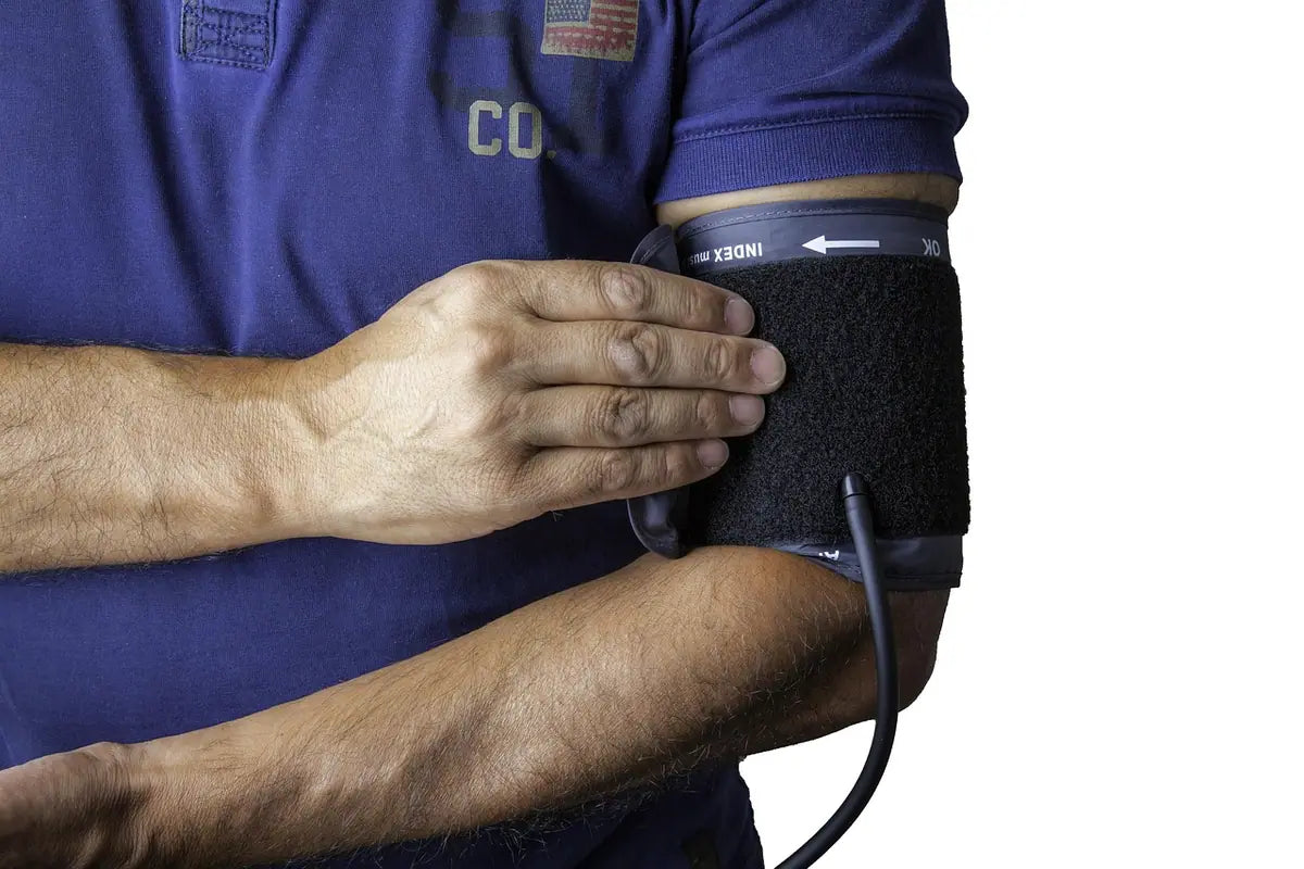 A man checking his blood pressure with a cuff on his arm