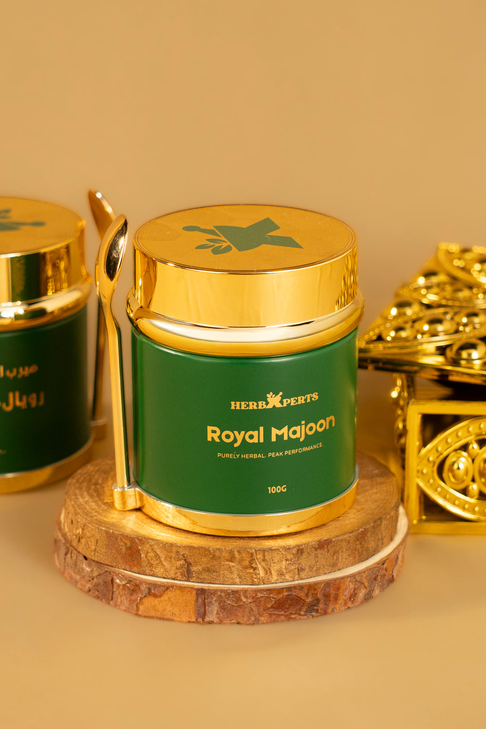 Royal Majoon jar on a wooden stand next to a gold box
